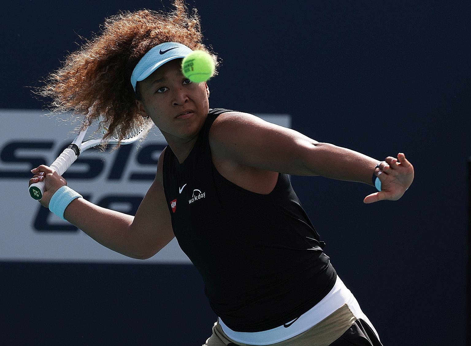 Naomi Osaka of Japan returns a shot during her women's singles fourth-round match against Elise Mertens of Belgium at the Miami Open. World No. 2 Osaka beat her opponent 6-3, 6-3 to set up a semi-final clash against Greece's Maria Sakkari.