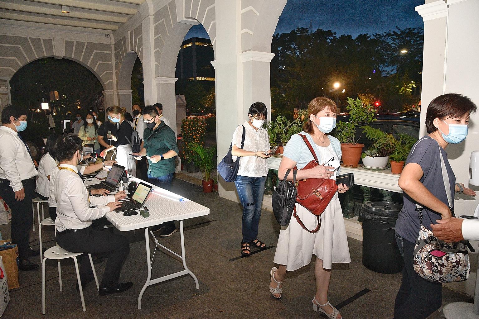 Churchgoers queueing at a SafeEntry check-in and temperature screening counter before a service at the Cathedral of the Good Shepherd yesterday. Restrictions on religious activities were eased last December under phase three of Singapore's reopening,