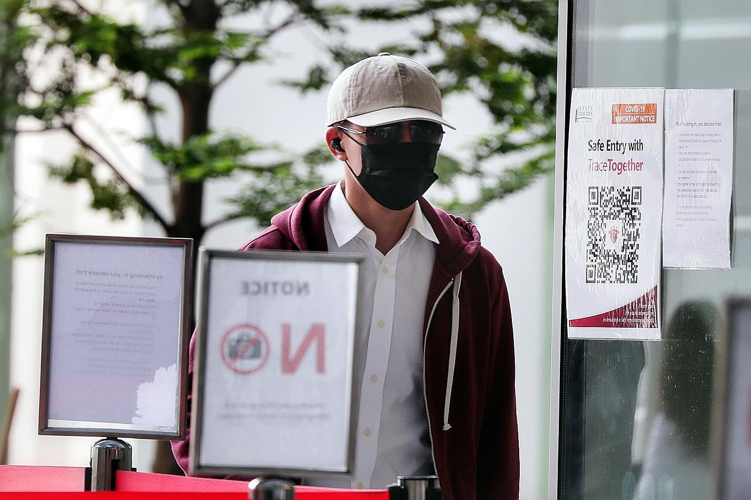 SMU student Lee Yan Ru, 24, arriving at the State Courts yesterday. He is alleged to have outraged the modesty of a woman by rubbing his private parts on her chest in a study room at the university in January 2019. ST PHOTO: KELVIN CHNG
