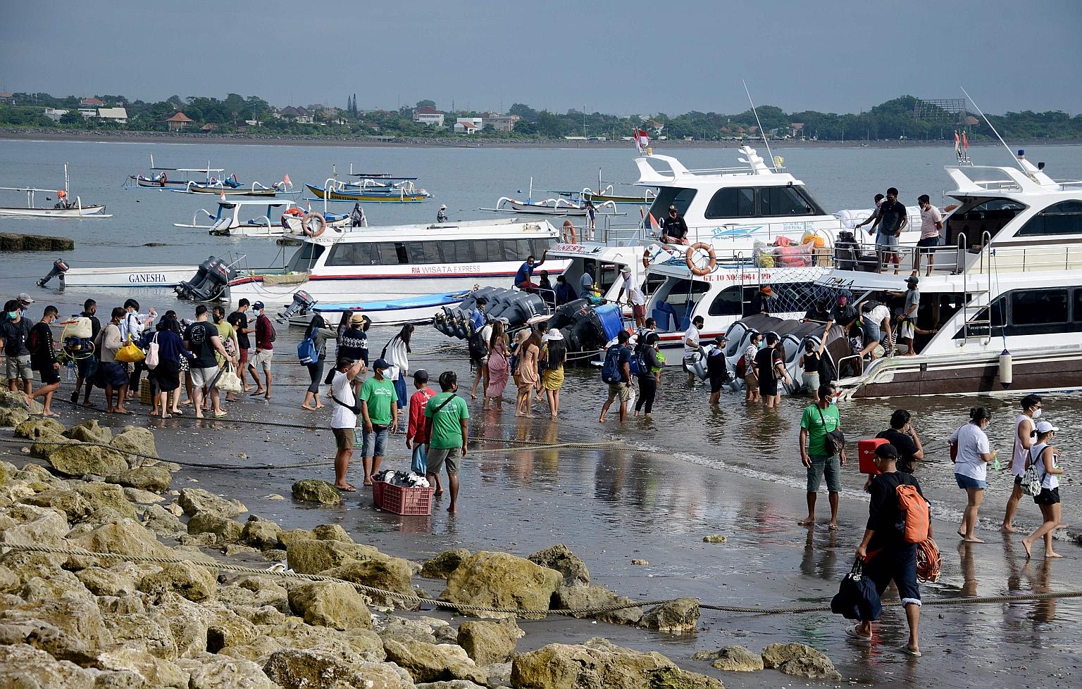 People preparing to board a fast boat from Sanur beach near Denpasar on the Indonesia resort island of Bali on Jan 7. Indonesian officials are in discussions with their counterparts in Singapore to allow limited travel to Indonesia.