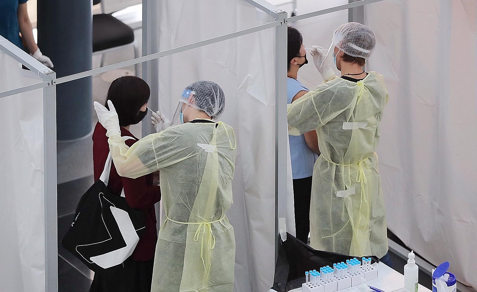 Attendees taking the antigen rapid test before the Tourism Industry Conference at Suntec Singapore Convention and Exhibition Centre yesterday. The certification is aimed at giving Mice players here a competitive edge.
