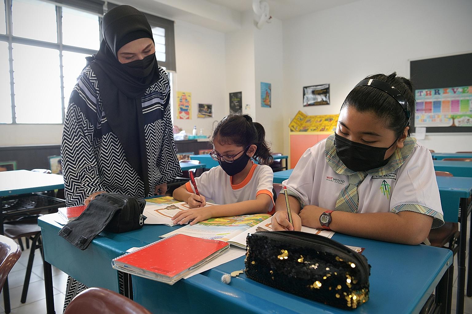Malay language teacher Khaizuran Supa'at and her pupils during a Higher Malay lesson yesterday at Westwood Primary School. She says the Higher Malay curriculum allows teachers to stretch high performing pupils to help them reach their fullest potenti