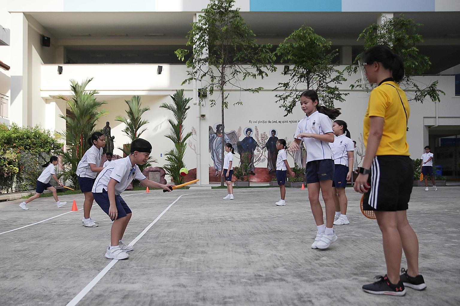 Pupils from Canossian School, a special education school for those with hearing loss, mingling with pupils from Canossa Catholic Primary School during a physical education lesson last week at the Canossian Village in MacPherson. Sister Theresa Seow, 