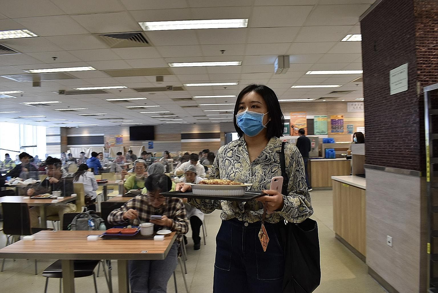 SHANDONG NATIVE, NEW IN HONG KONG Ms Yue Meng Ying inside a cafeteria at Hong Kong Baptist University, where she is a student. She said her experiences with discrimination are rare and usually linked to language as she cannot speak Cantonese. BORN IN