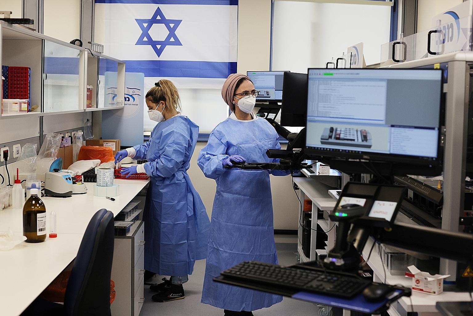 Technicians at Maccabi Healthcare Services' Covid-19 public laboratory performing tests in Rehovot, Israel, on Feb 9. The researchers from Tel Aviv University and Israel's largest healthcare provider, Clalit, cautioned that the study had only a small