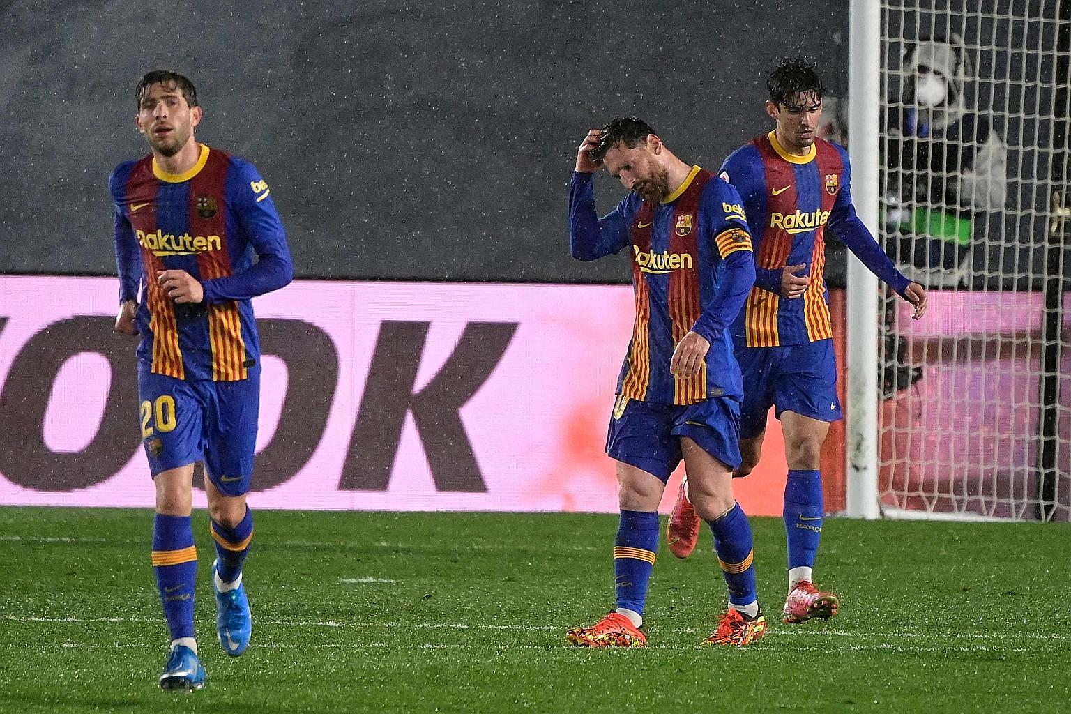 From left: Barcelona's Sergi Roberto, Lionel Messi and Pedri are crestfallen after the Catalans' 2-1 away loss to Real Madrid on Saturday, which derailed their hunt for a 27th league title.
