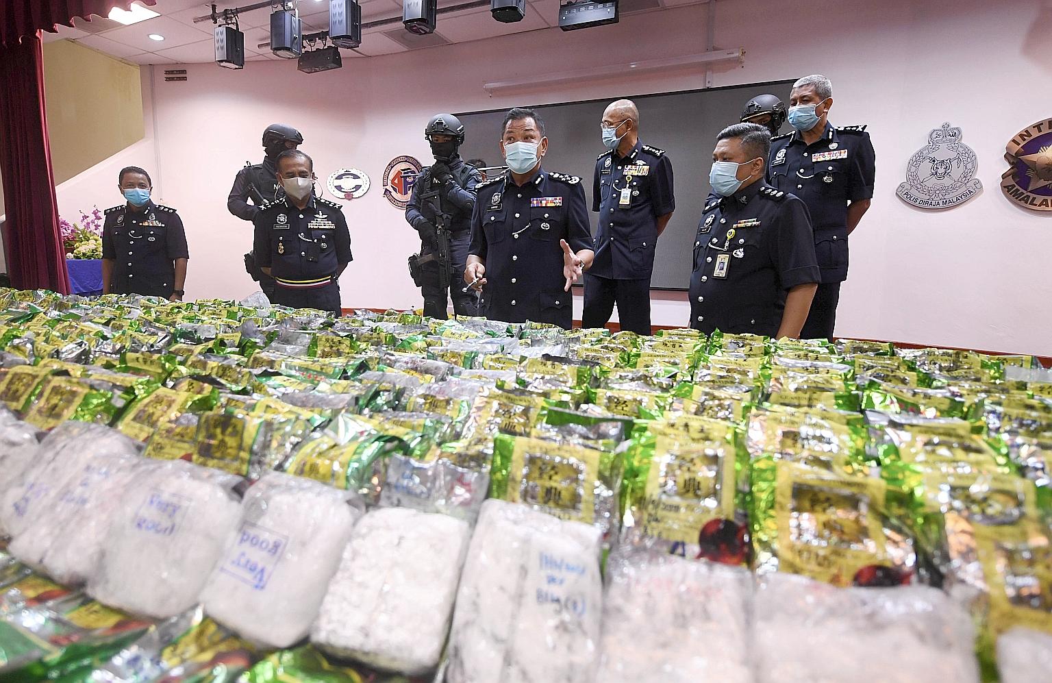 Malaysia's national police chief Abdul Hamid Bador (centre) last month showing the media a haul of methamphetamine seized in a raid. The police succeeded in crippling a Thai drug smuggling syndicate. Last May, the United Nations Office on Drugs and C