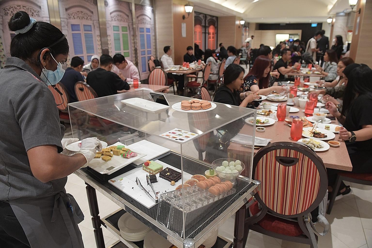 Popular buffet eatery Carousel at Royal Plaza on Scotts resumed its buffet line yesterday, but diners are not allowed to serve themselves as they did before the pandemic hit. Instead, servers must dish out the food items. In addition, the food being 