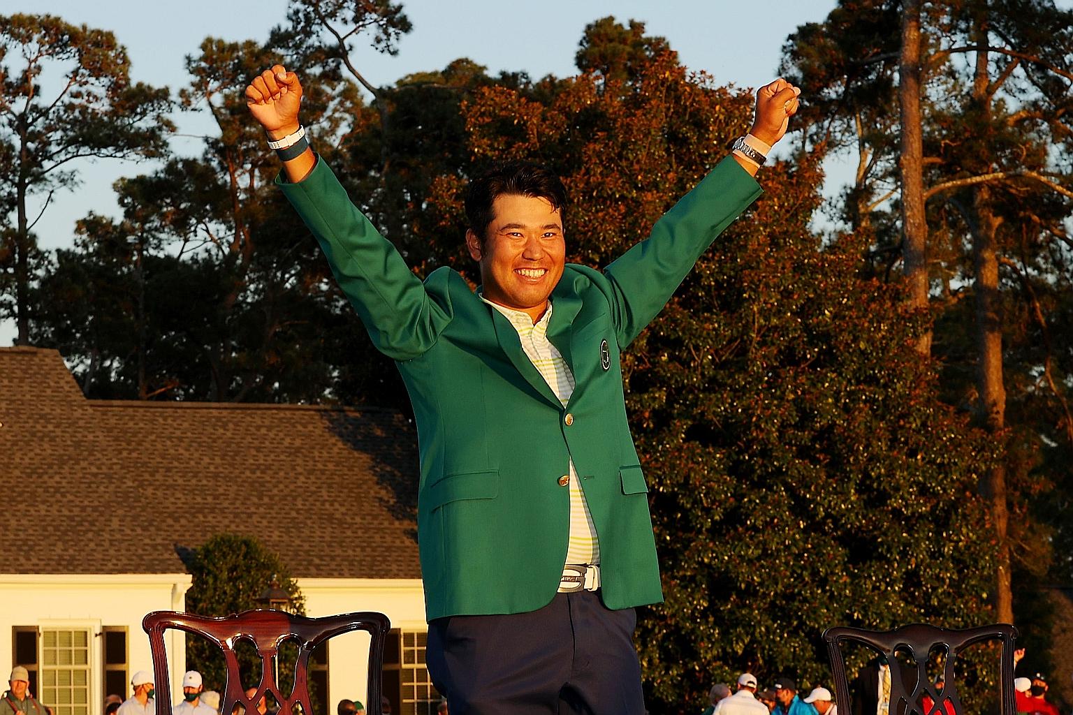 Hideki Matsuyama in the winner's Green Jacket with his arms aloft after claiming the Masters at Augusta National Golf Club. He is the first Japanese man to win one of golf's Majors. PHOTO: AGENCE FRANCE-PRESSE