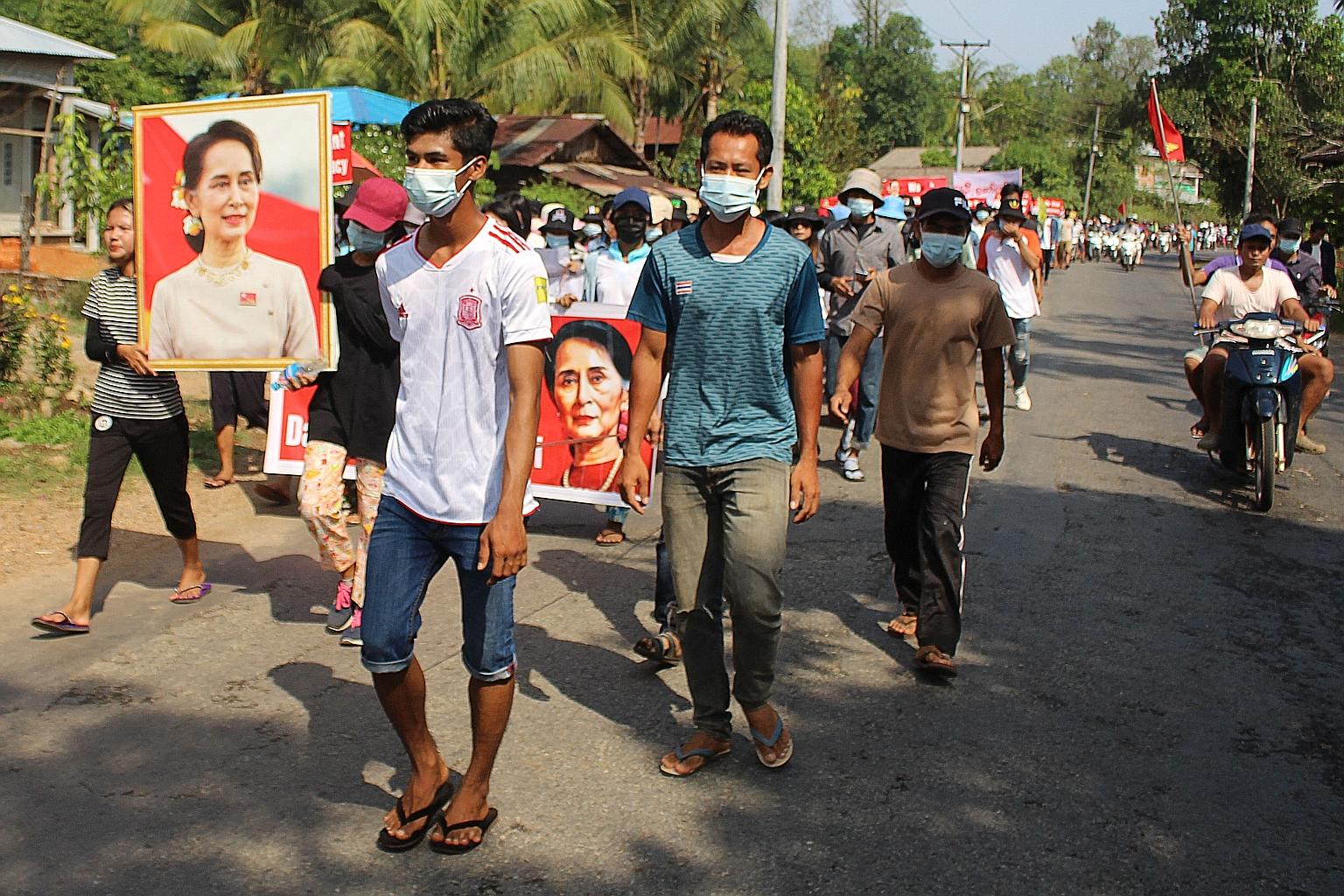 Protesters carrying portraits of detained civilian leader Aung San Suu Kyi while taking part in a demonstration against the military coup in Dawei city last week.
