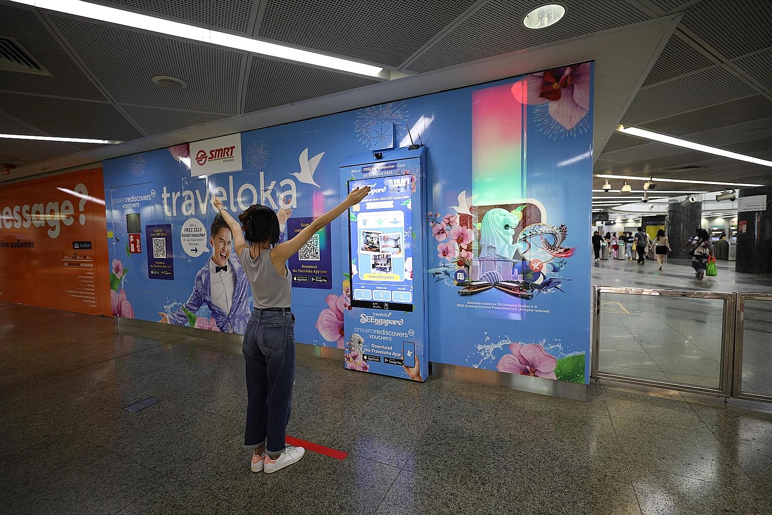 A commuter participating in Traveloka's interactive marketing campaign at an MRT station. The Indonesian online travel services firm is poised to list via a special purpose acquisition company, while Singapore ride-hailing giant Grab will this week u