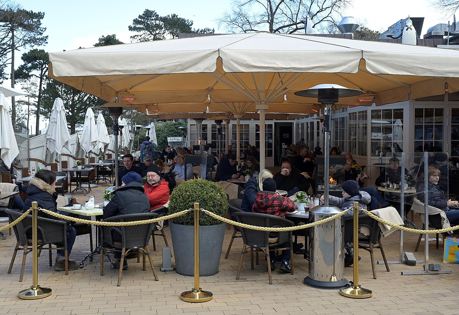 People at a restaurant in the German coastal town of Timmendorfer Strand on Monday, after outdoor catering was allowed by the authorities. But with Covid-19 infections rising rapidly in some areas in Germany, Chancellor Angela Merkel's government is 