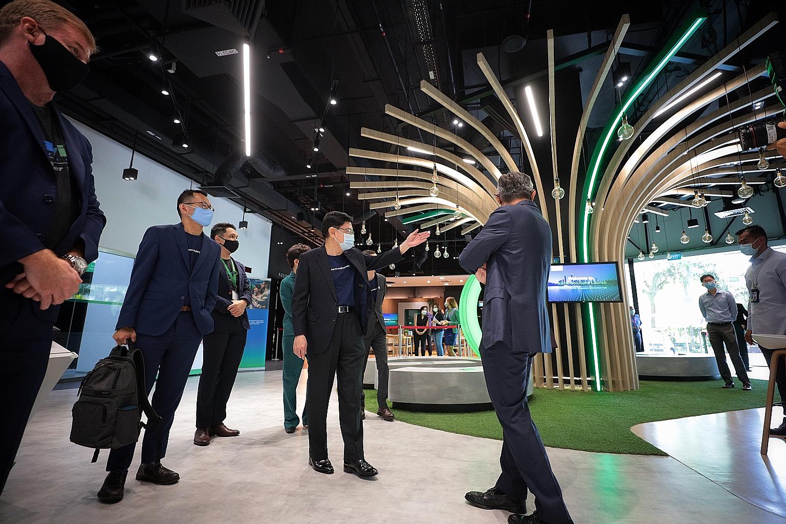 Deputy Prime Minister Heng Swee Keat (centre) during a visit to Schneider Electric in Kallang yesterday. With him were (from left) NaviX Solutions chief executive Simon Claringbold, National Research Foundation deputy CEO Beh Kian Teik and Mr Tommy L