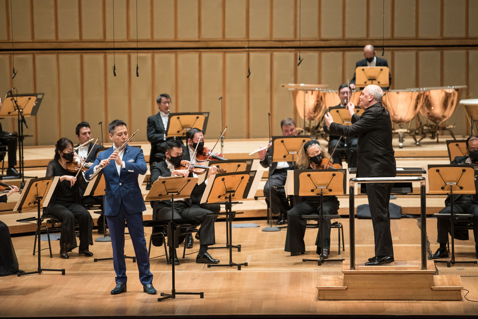 Singapore Symphony Orchestra's principal flautist Jin Ta (in blue suit) and chief conductor Hans Graf (on podium) in Flurry Of The Flute last Saturday.