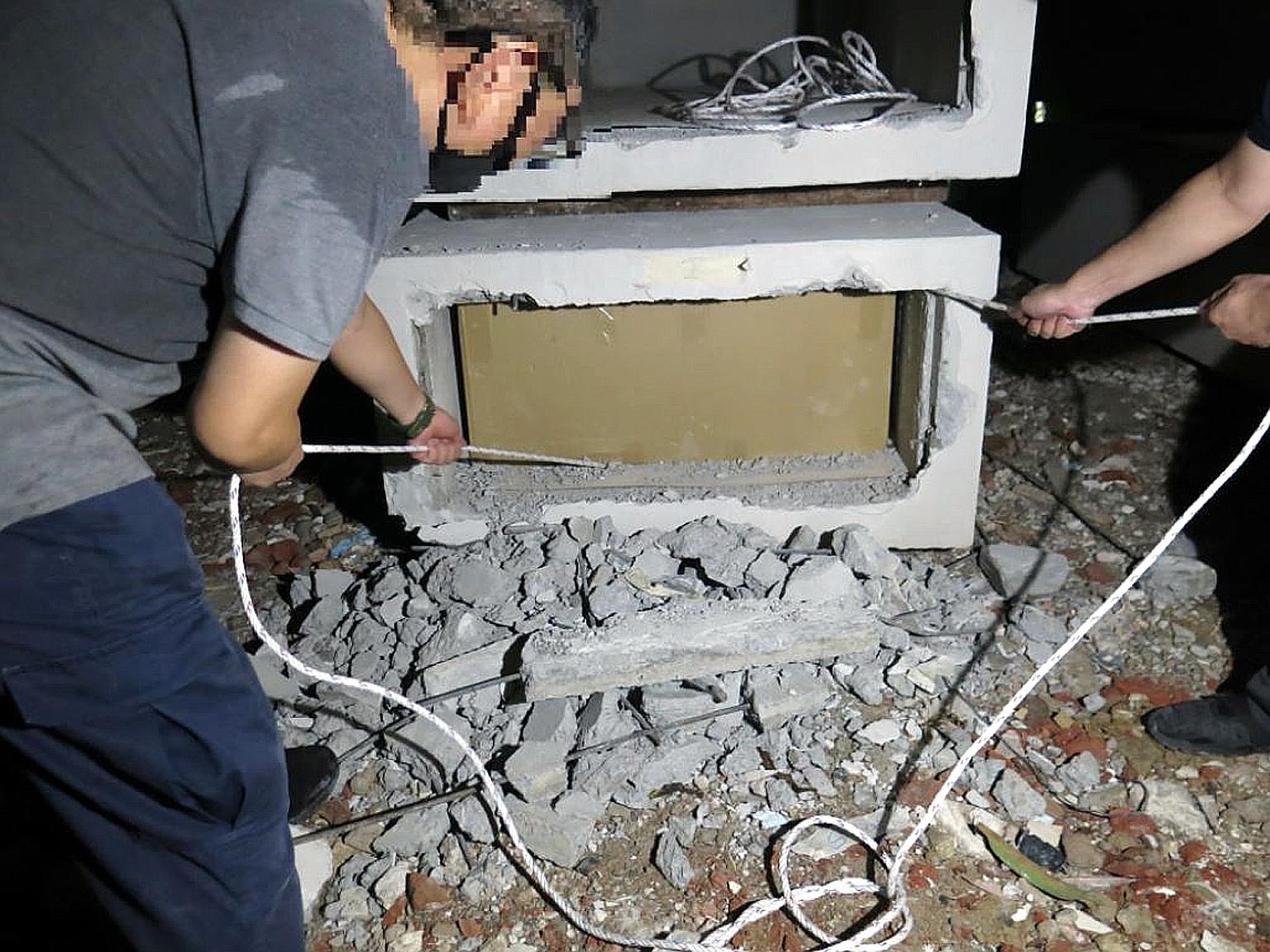 Duty-unpaid cigarettes concealed in a hollow compartment of concrete blocks at a storage yard in Penjuru Walk last Thursday. The total duty and goods and services tax evaded on the cartons seized in the raid amounted to about $732,730 and $58,780 res