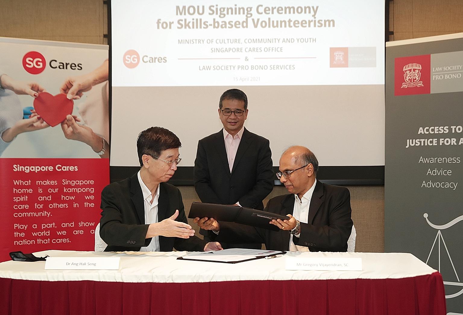 Culture, Community and Youth Ministry deputy secretary Ang Hak Seng (left) and Law Society Pro Bono Services chairman Gregory Vijayendran at the MOU signing ceremony yesterday, with Culture, Community and Youth Minister Edwin Tong witnessing the even