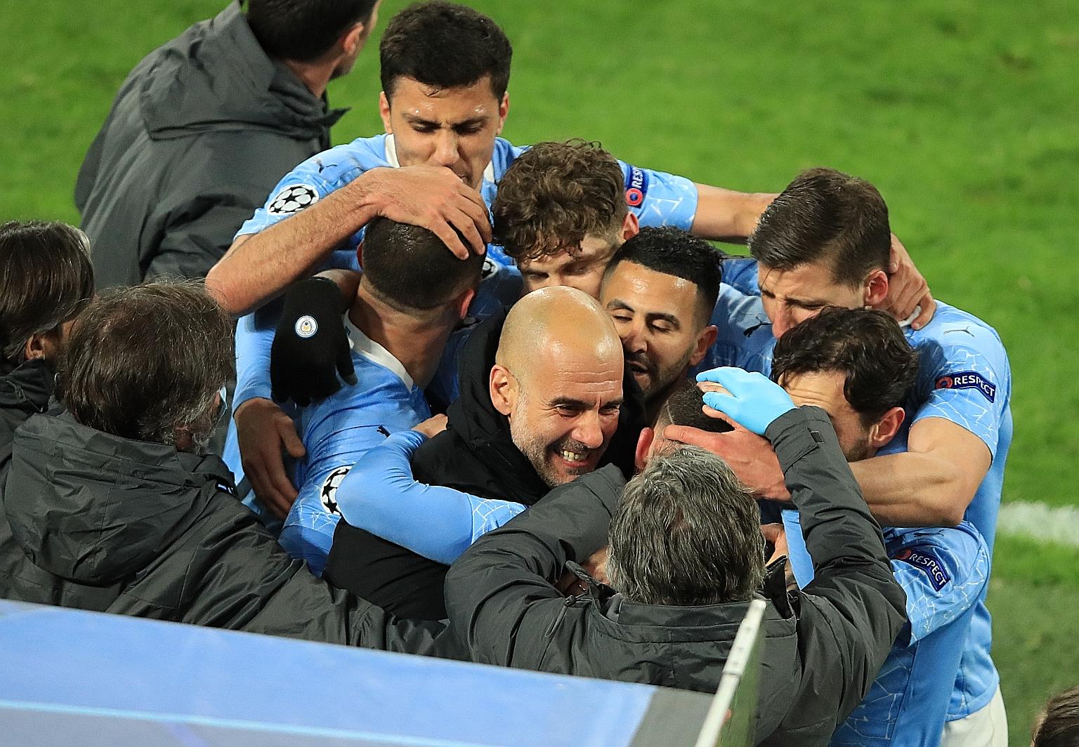Pep Guardiola and his Manchester City players celebrating after Phil Foden scored the winner in the 2-1 victory over Borussia Dortmund on Wednesday.