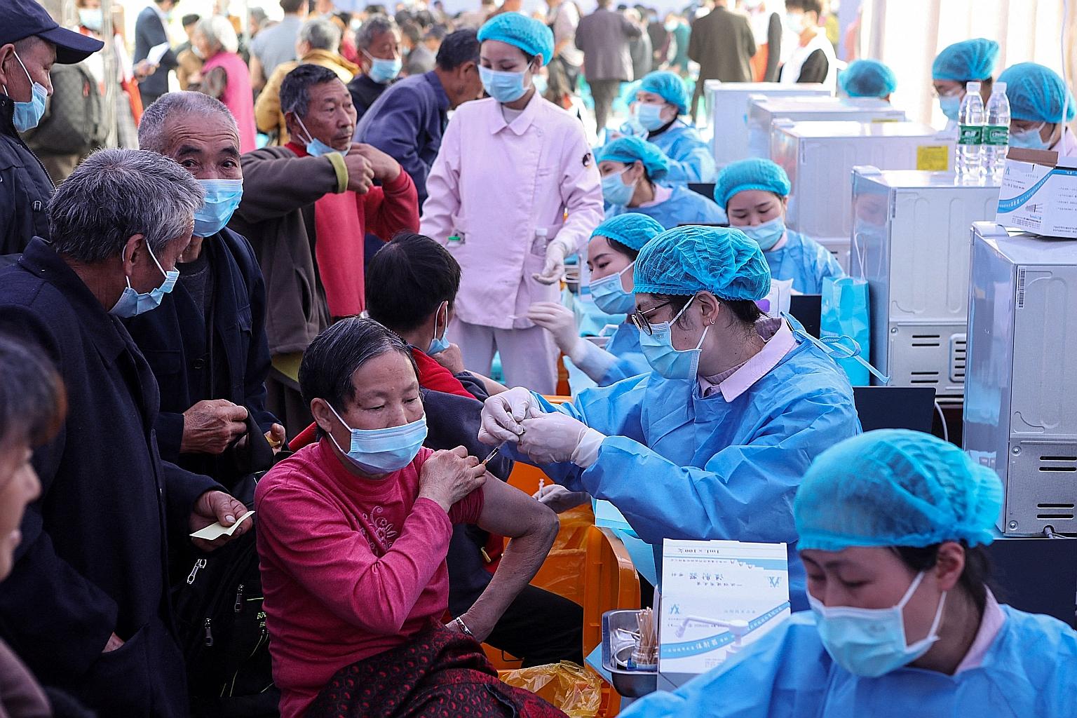 Residents receiving Covid-19 shots in China's south-western city of Chongqing. China aims to vaccinate 40 per cent of its population, or about 560 million people, by the end of June, but uptake has been less than enthusiastic. PHOTO: AGENCE FRANCE-PR