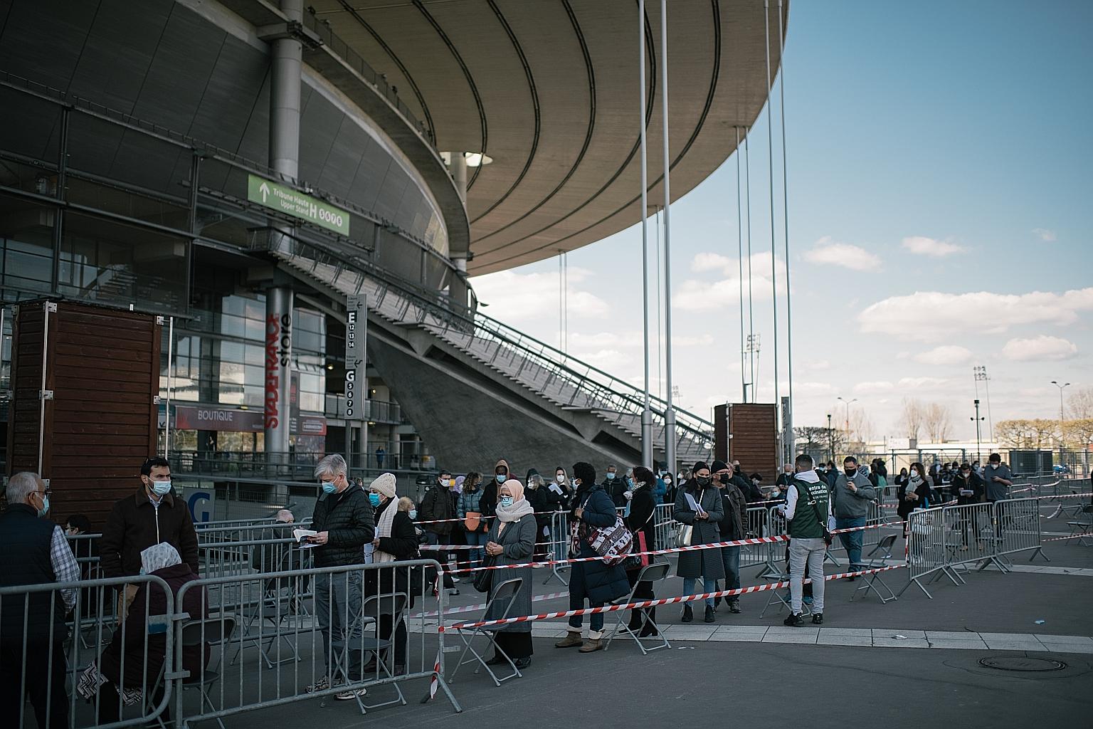 People queueing for Covid-19 jabs last week in the suburb of Saint-Denis, outside Paris. The European Union is banking on Pfizer's early shipment of vaccine doses to keep the bloc's inoculation programme on track. PHOTO: NYTIMES