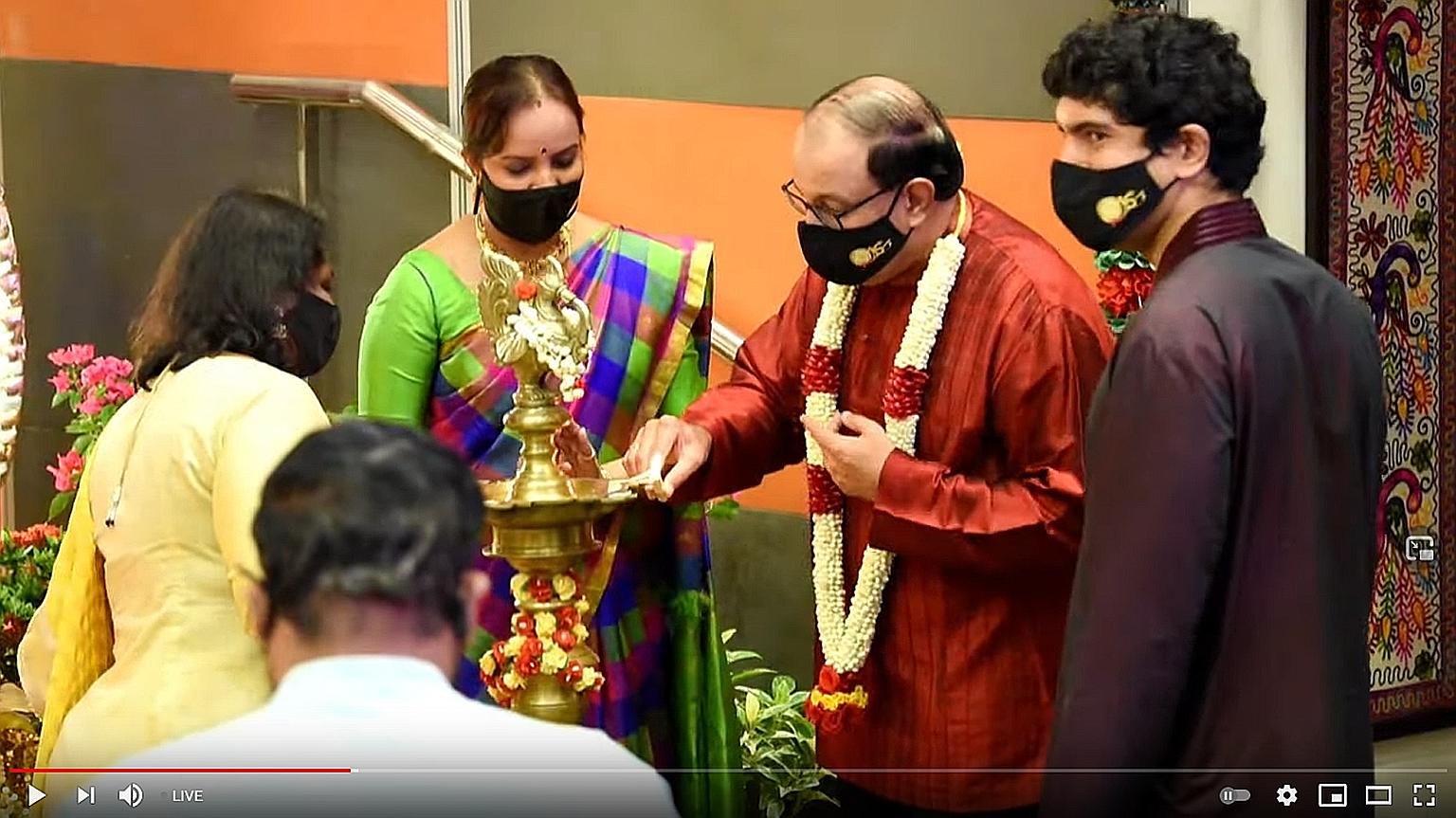 Minister for Communications and Information S. Iswaran, seen here with Tamil Language Learning and Promotion Committee chairman and MP Vikram Nair (right), lighting a lamp at the launch of the book Naavil Thamizh Naalum Thamizh (Speak Tamil, Speak It