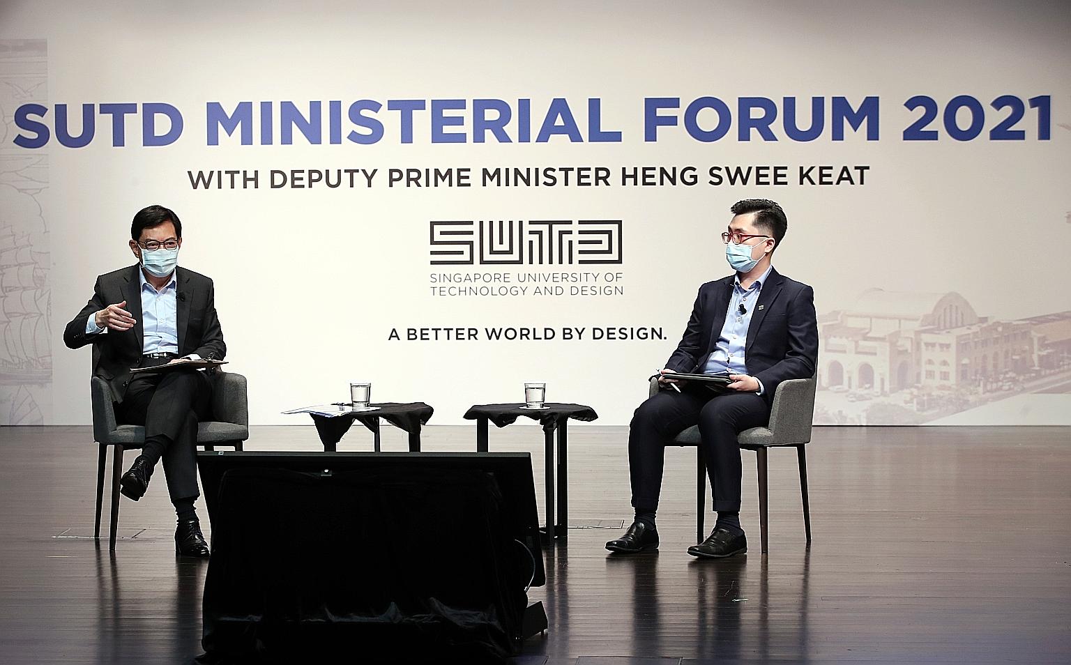 Deputy Prime Minister Heng Swee Keat speaking to students during yesterday's dialogue at the Singapore University of Technology and Design. The dialogue was moderated by final-year student Ng Jin Da (right). In his speech, Mr Heng suggested three new