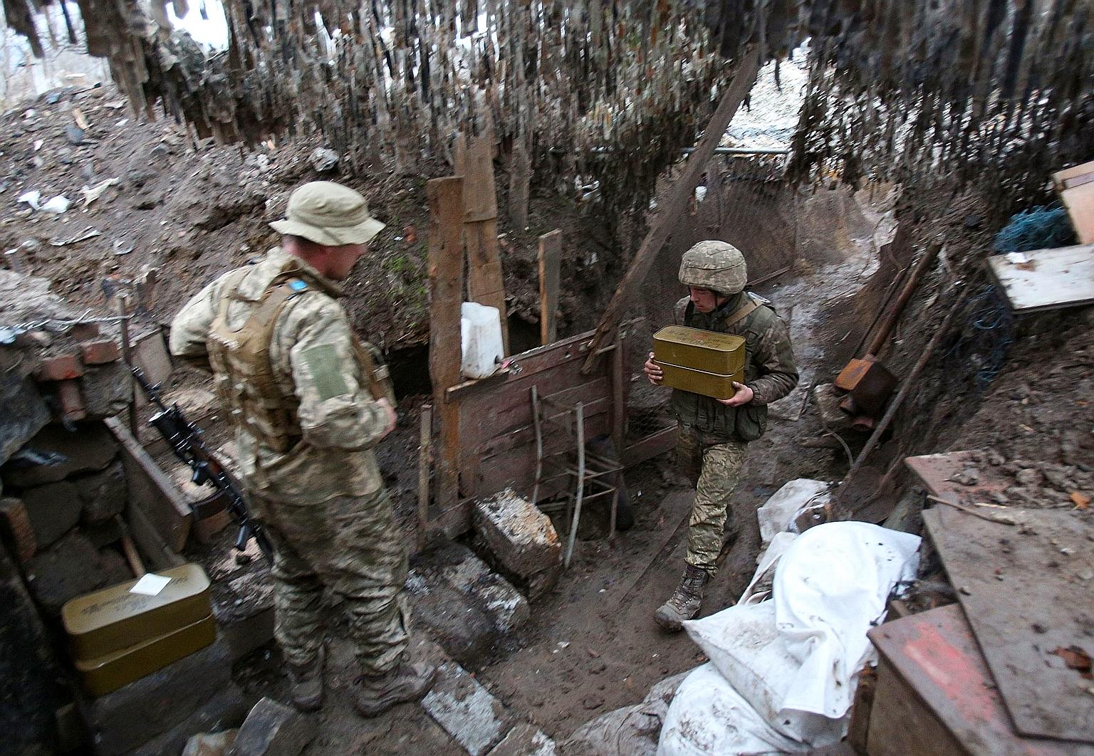 Ukrainian servicemen keeping watch at a position on the front line with Russia-backed separatists near Gorlovka in the Donetsk region on Wednesday. Tensions between Russia and Ukraine have soared in recent days. PHOTO:AGENCE FRANCE-PRESSE