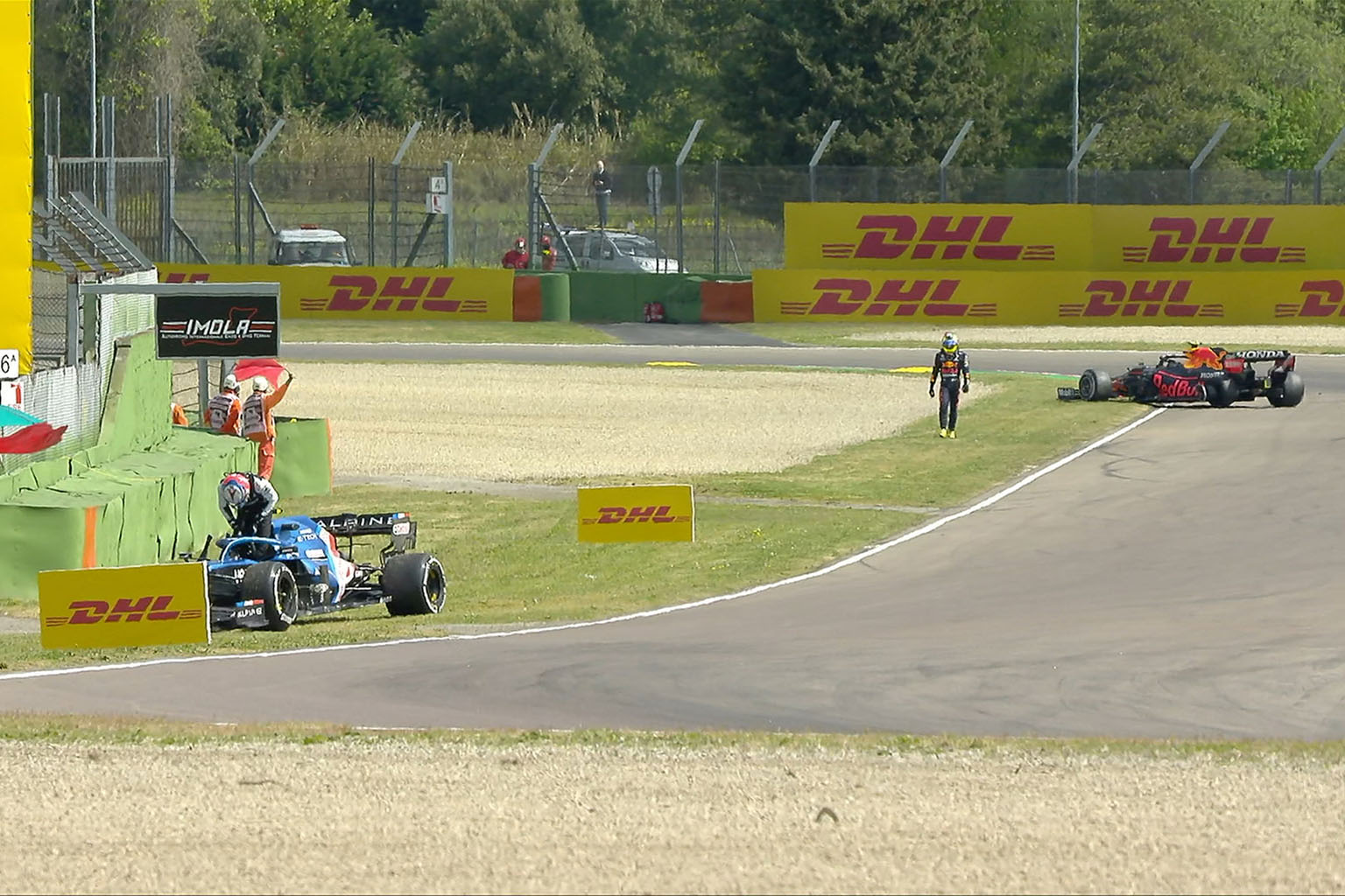 The red flag is waved during yesterday's first practice for the Emilia Romagna Grand Prix at Imola after Red Bull's Sergio Perez (right) and Alpine's Esteban Ocon came together.