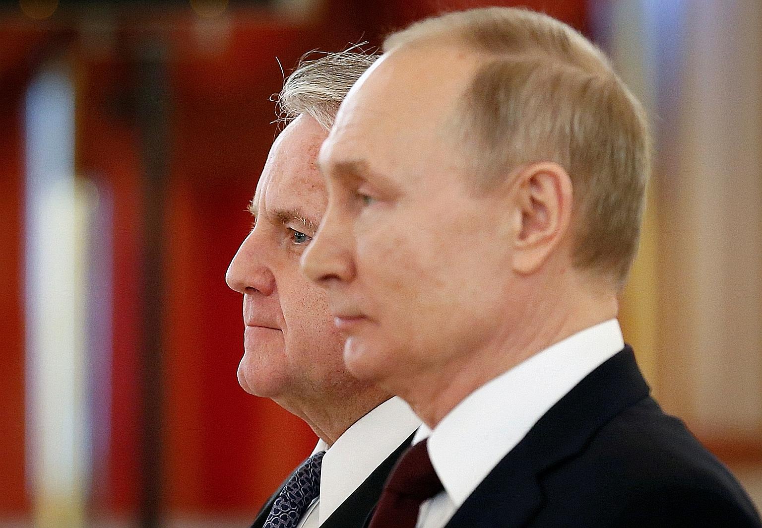 Russian President Vladimir Putin with US Ambassador to Russia John Sullivan at the Kremlin in February last year. On Friday, Mr Sullivan was summoned to a meeting with a senior Kremlin foreign policy official and advised to return to the US for consu
