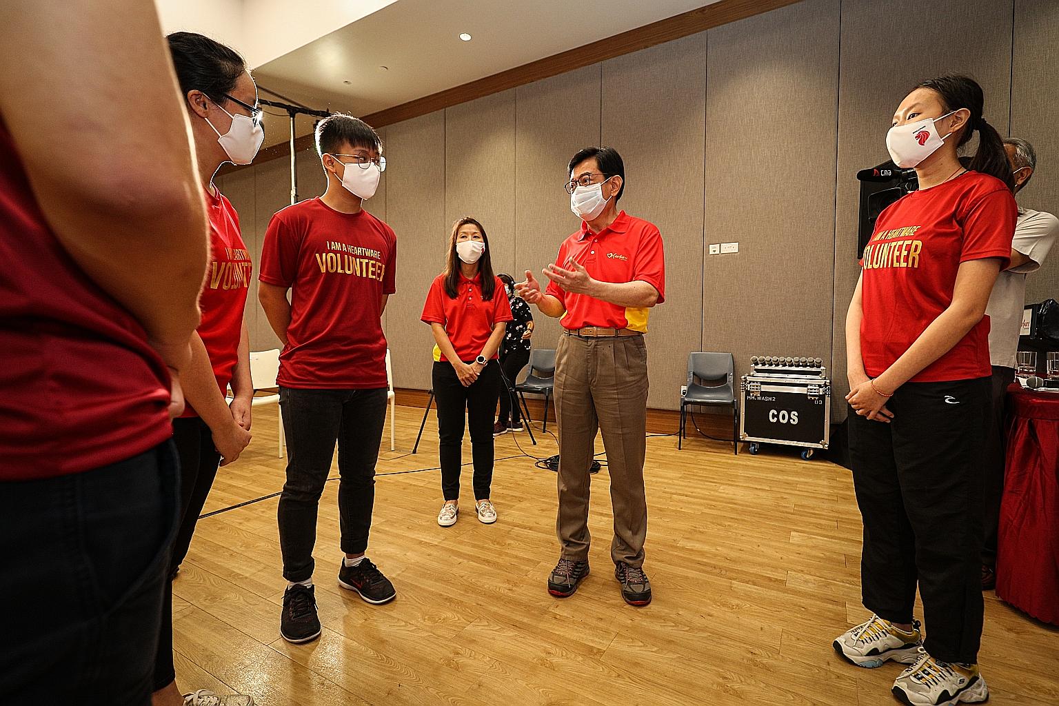 Deputy Prime Minister Heng Swee Keat with youth volunteers at an event organised by charity organisation Heartware Network yesterday. The organisation is partnering SG Cares and Temasek Foundation to provide more opportunities for young people to vol