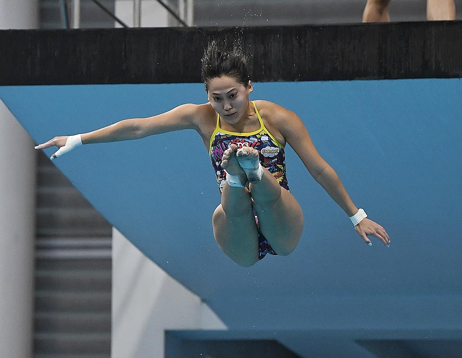 Freida Lim taking a dive during training for the 10m platform at the OCBC Aquatic Centre yesterday. She is among seven divers who will compete in the Diving World Cup in Tokyo, which doubles as an Olympic qualifier. ST PHOTO: KHALID BABA