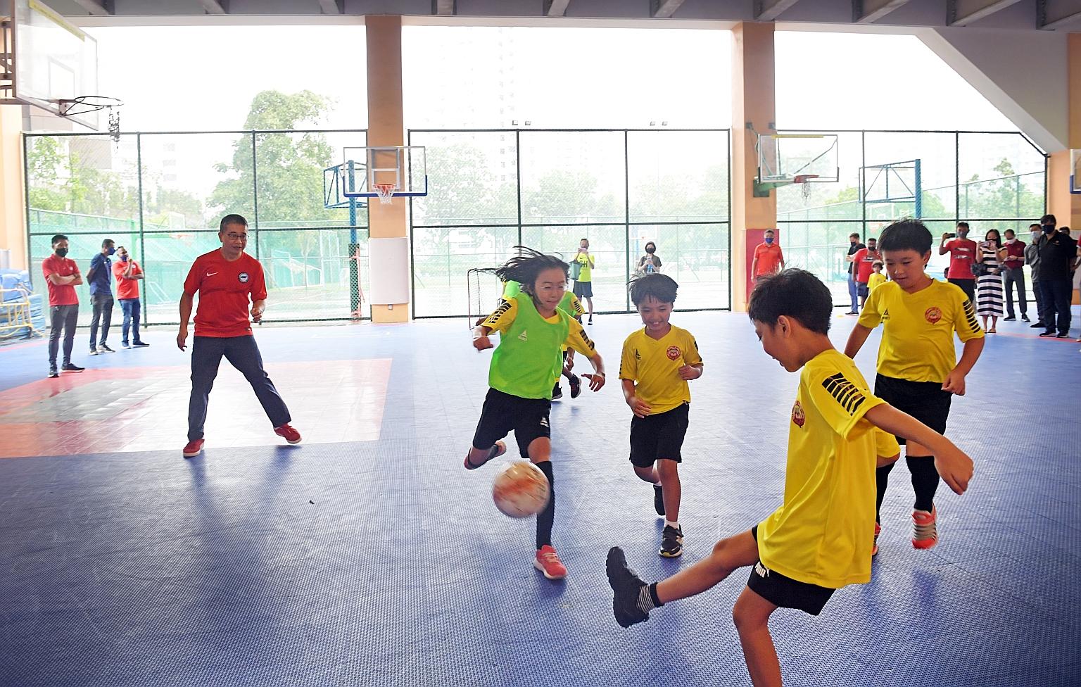Minister for Culture, Community and Youth Edwin Tong joining a game at the HotShotz programme at Victoria School yesterday.
