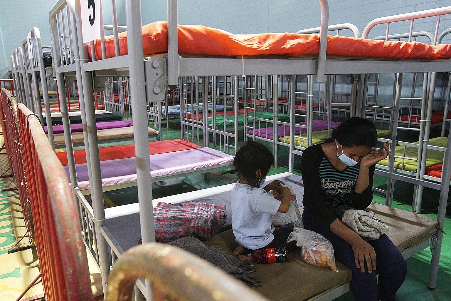 A migrant and her daughter at a new shelter for undocumented migrants who are trying to enter the US, in the Mexican city of Ciudad Juarez. The White House had capped the number of refugees allowed into the US this year at the Trump era's 15,000, but
