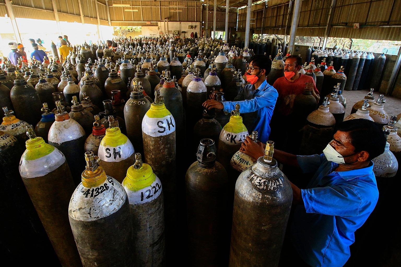 Workers preparing to fill medical oxygen cylinders for use on hospitalised Covid-19 patients on the outskirts of Jabalpur in central India. The country reported 261,500 new Covid-19 cases and 1,501 deaths on Saturday, according to the Indian Health M