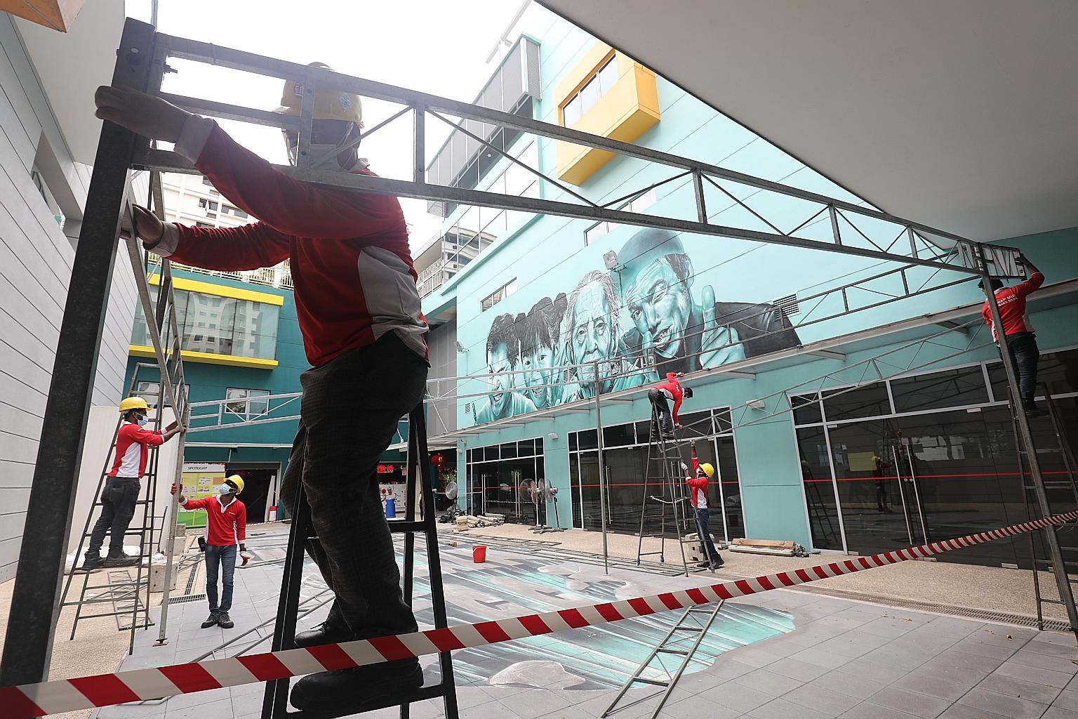 Workers setting up a vaccination centre at Woodlands Galaxy Community Club in January. Typically, it takes 10 days to transform an empty room - usually a multipurpose hall in a community club - into a full-fledged vaccination centre.