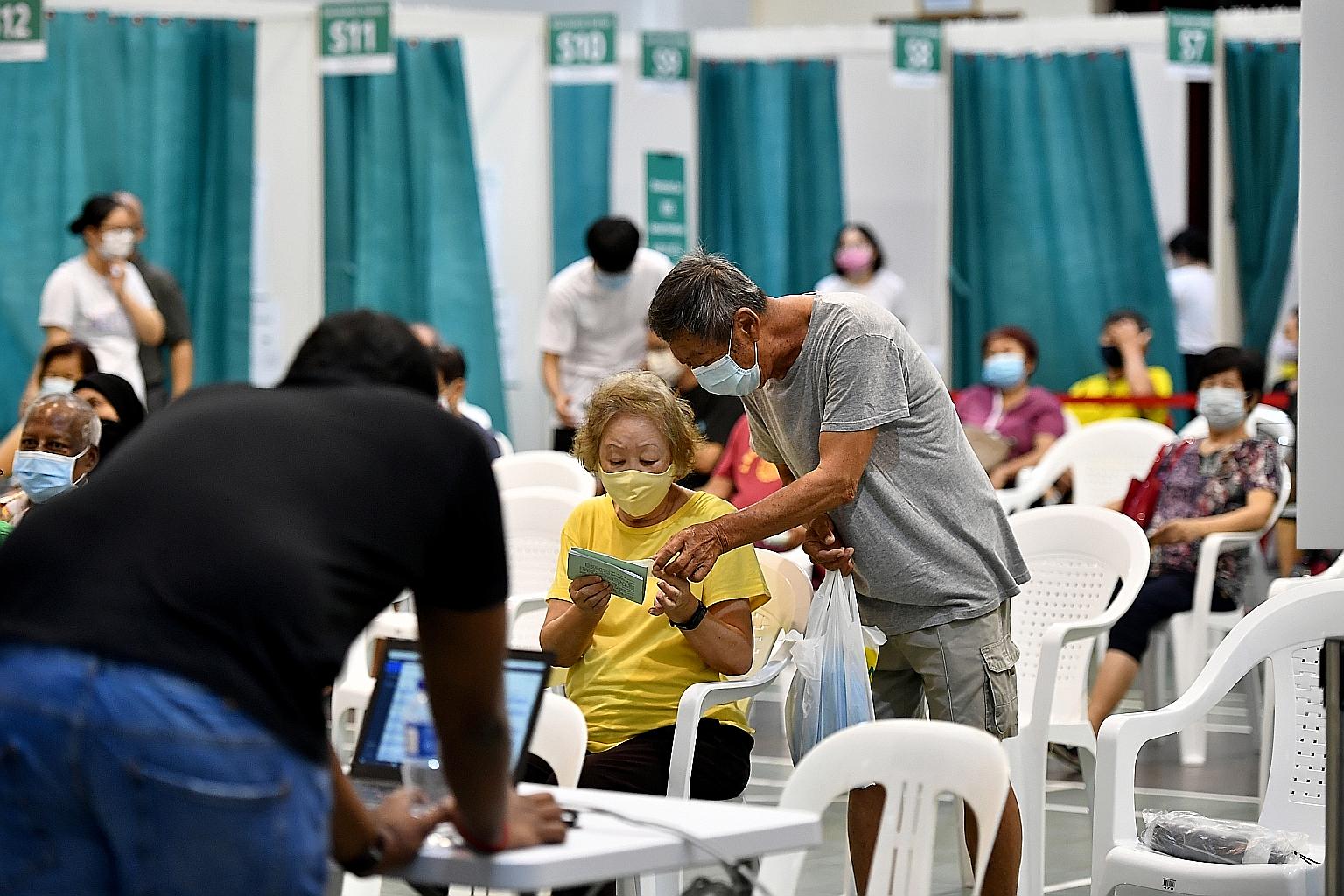 Seniors waiting to get their Covid-19 vaccination at Hong Kah North Community Club last month. About 60 per cent of eligible seniors aged 70 and above have received the jab or booked their appointments. This is lower than the close to 70 per cent of 