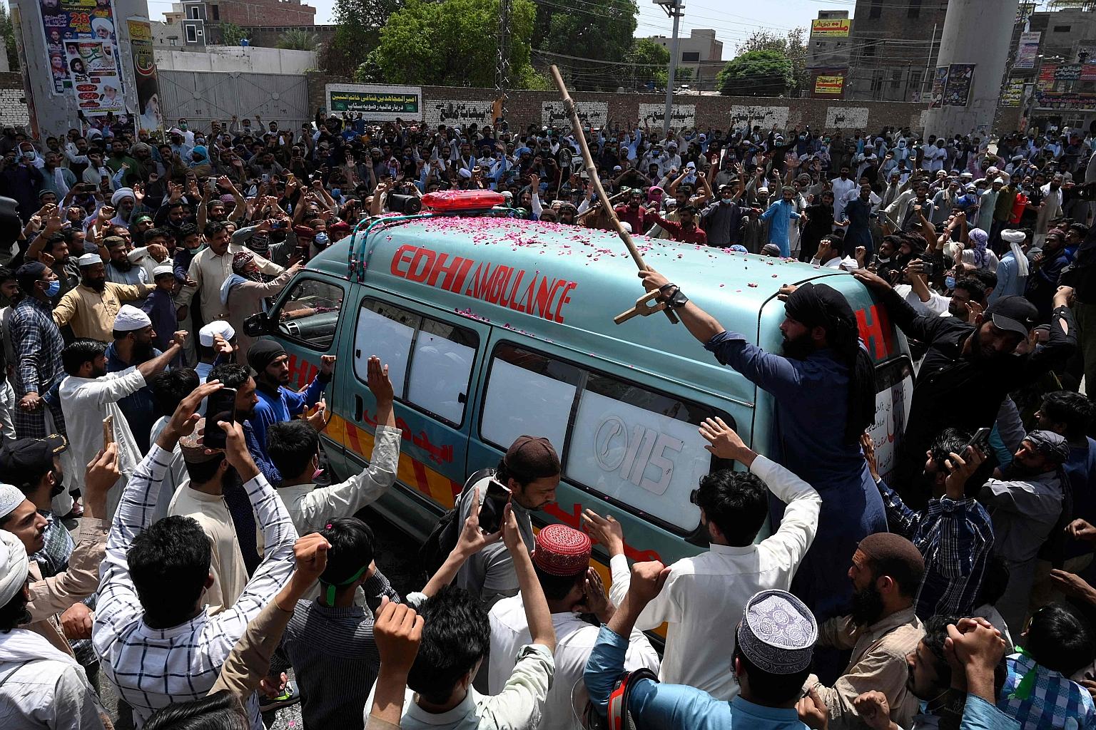 An ambulance in Lahore yesterday transporting the body of a Tehreek-e-Labbaik Pakistan activist killed in a clash with security forces during a protest, after the party's leader was detained following his calls for the expulsion of the French ambassa