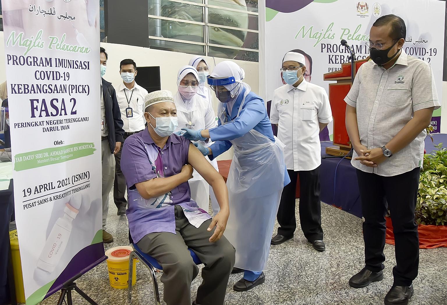 A man being vaccinated at the Science and Creativity Centre in Terengganu yesterday as Malaysia began the second phase of its Covid-19 vaccination drive, targeting senior citizens and people with disabilities and comorbidities.