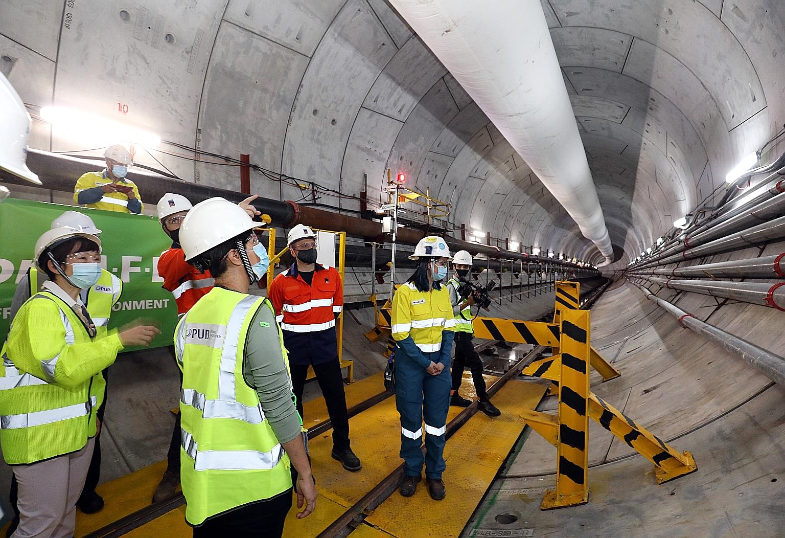 Second Minister for Finance Indranee Rajah (far left) at a site in the Penjuru Road area for phase two of the Deep Tunnel Sewerage System project. About 24km of the 100km-long conveyance system for this phase has been completed.