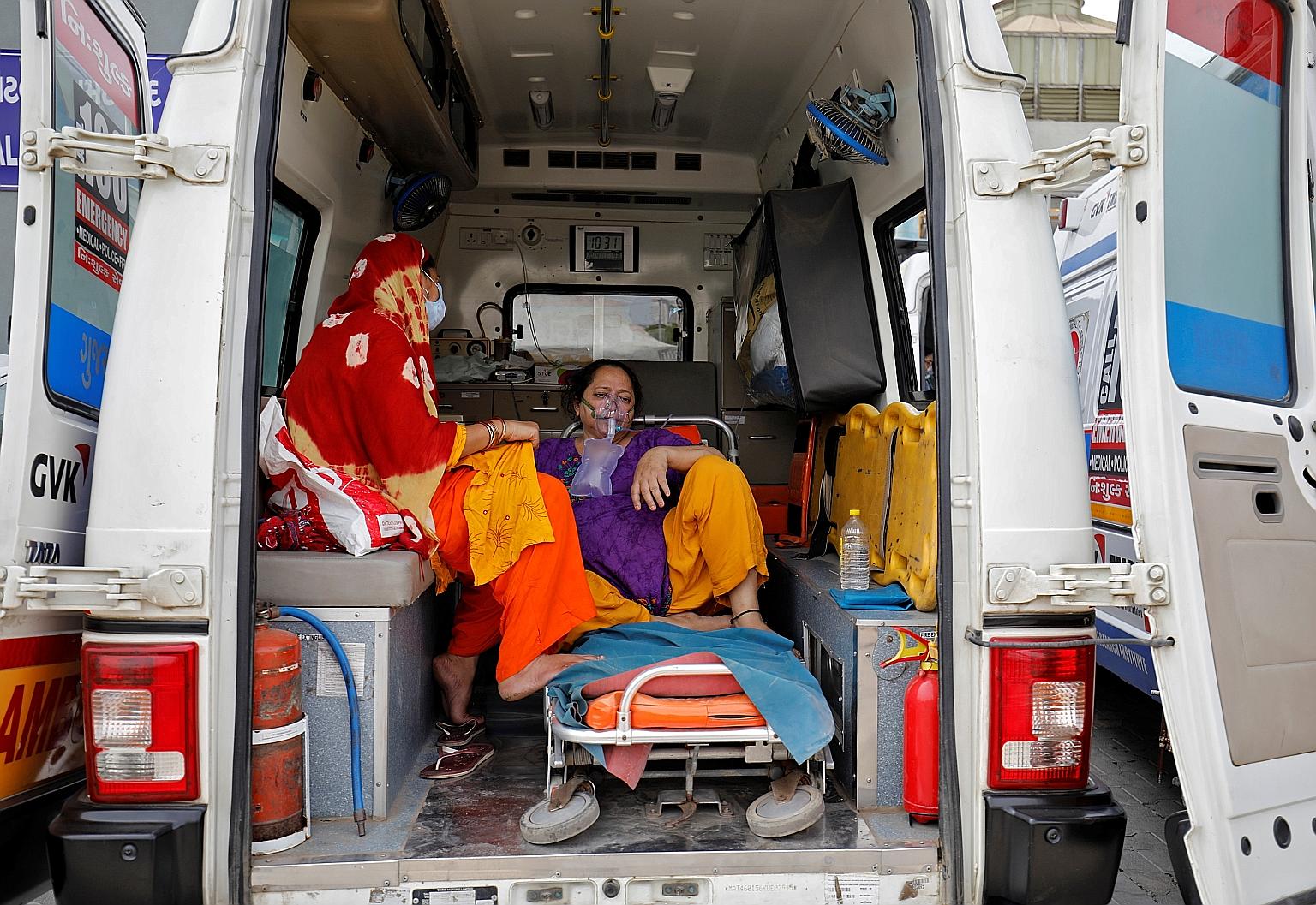 A patient inside an ambulance waiting to enter a hospital for treatment in Ahmedabad. India is adding over 200,000 new infections every day and the surge is putting pressure on its health infrastructure.