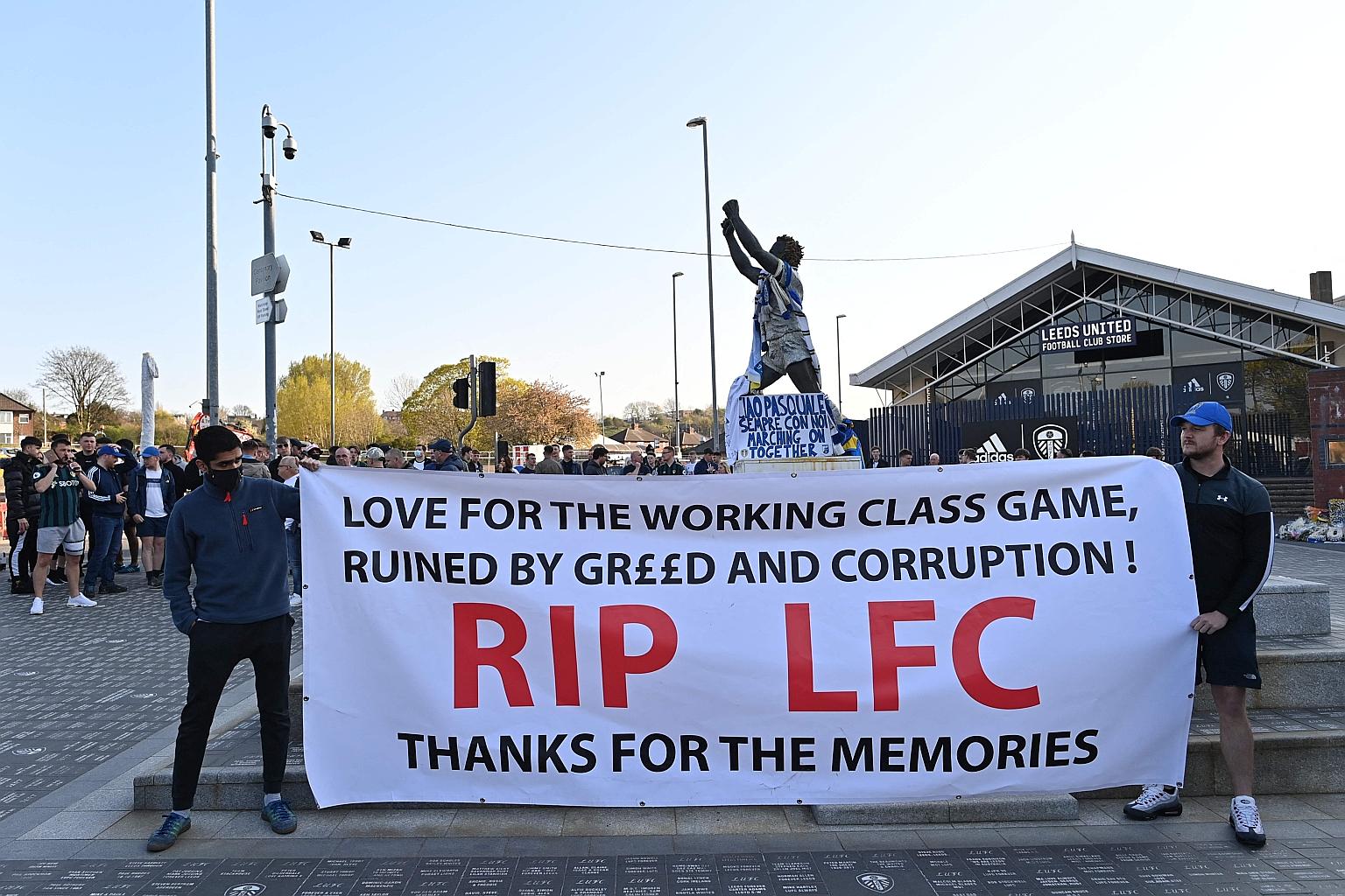 Leeds United fans holding a banner to protest against the involvement in the proposed European Super League of Liverpool, their opponents in Monday's Premier League game, outside the Elland Road stadium.