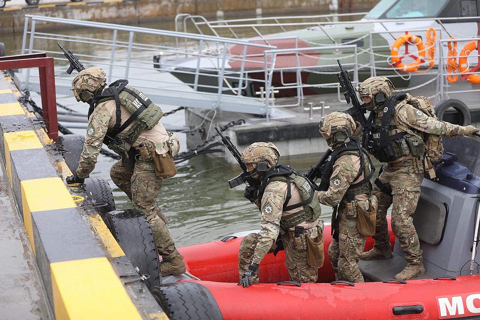 This handout picture released by the Ukrainian Interior Ministry press service shows servicemen of the National Guard taking part in a military drill near the Ukrainian Azov Sea port of Mariupol on Monday. The US State Department branded as an "unpro
