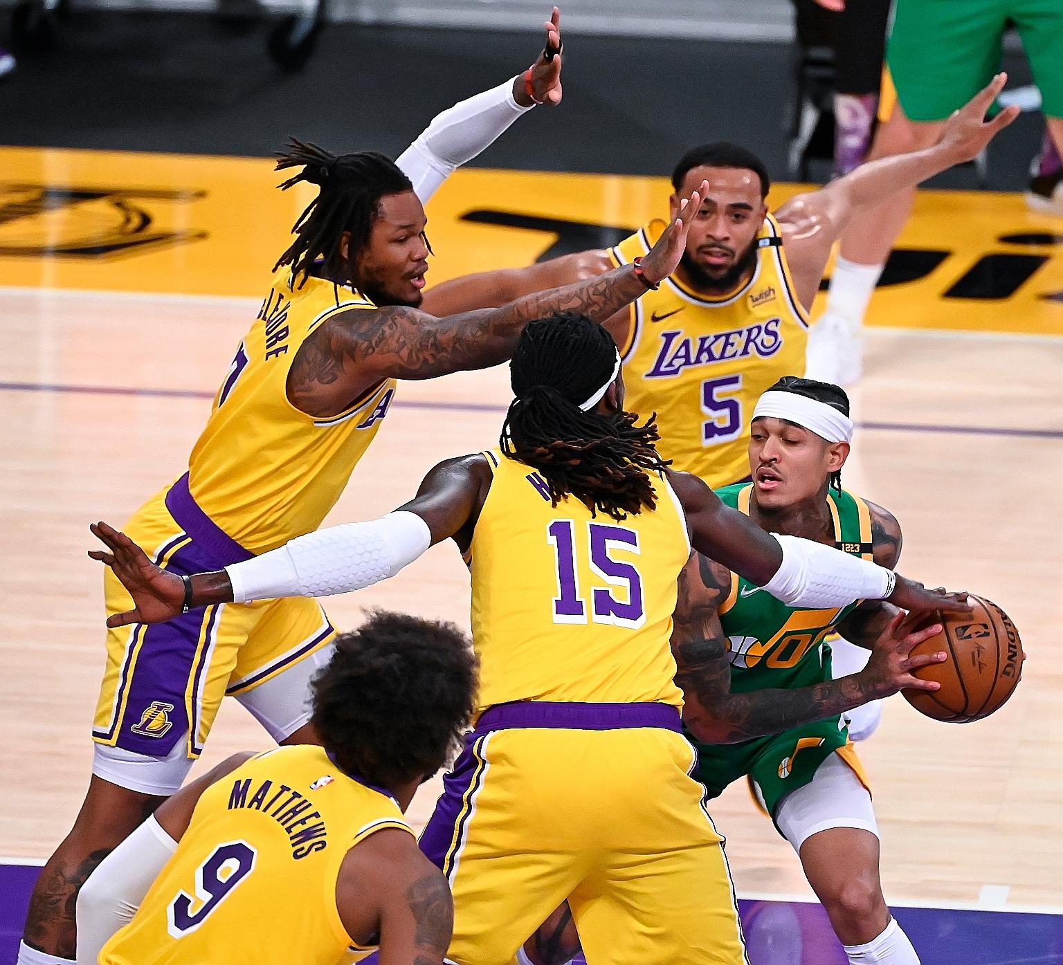 Utah Jazz guard Jordan Clarkson, who had a team-high 22 points, attempts to get past four Lakers players in their game on Monday.