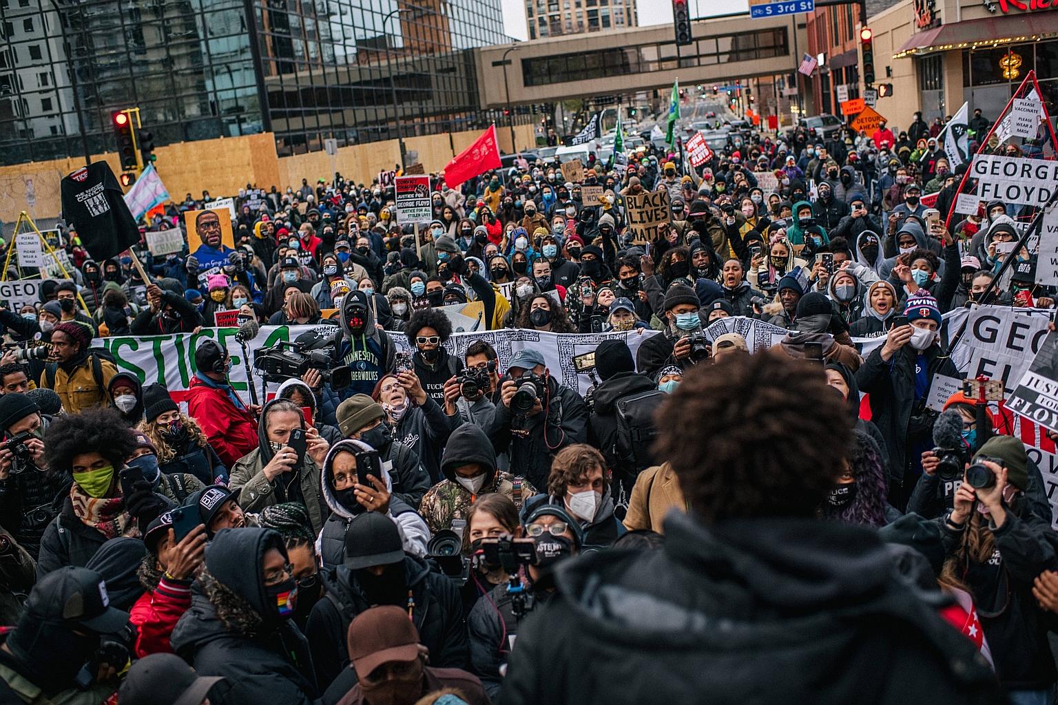 A demonstration demanding justice for Mr George Floyd in Minneapolis on Monday. On May 25 last year, then police officer Derek Chauvin knelt on the neck of the dying handcuffed black man in an arrest. PHOTO: AGENCE FRANCE-PRESSE