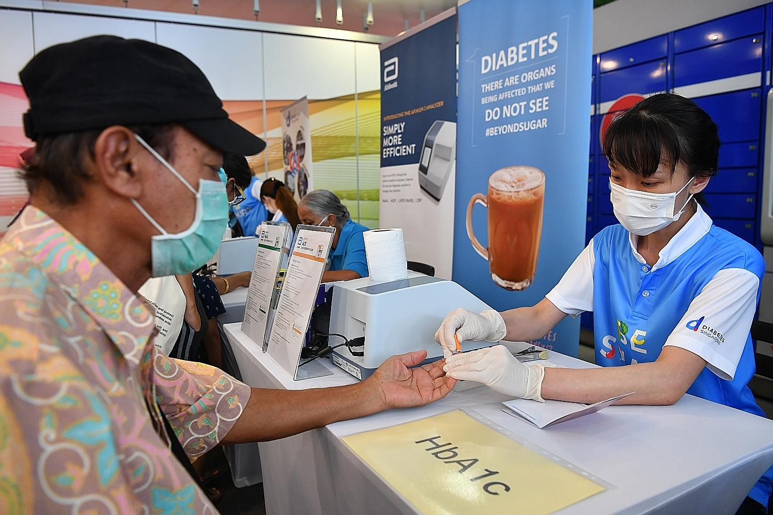 A man taking a diabetes test at an event earlier this month. A study found that almost half of the respondents - 44.8 per cent - said they did not know where to get free diabetes screening.