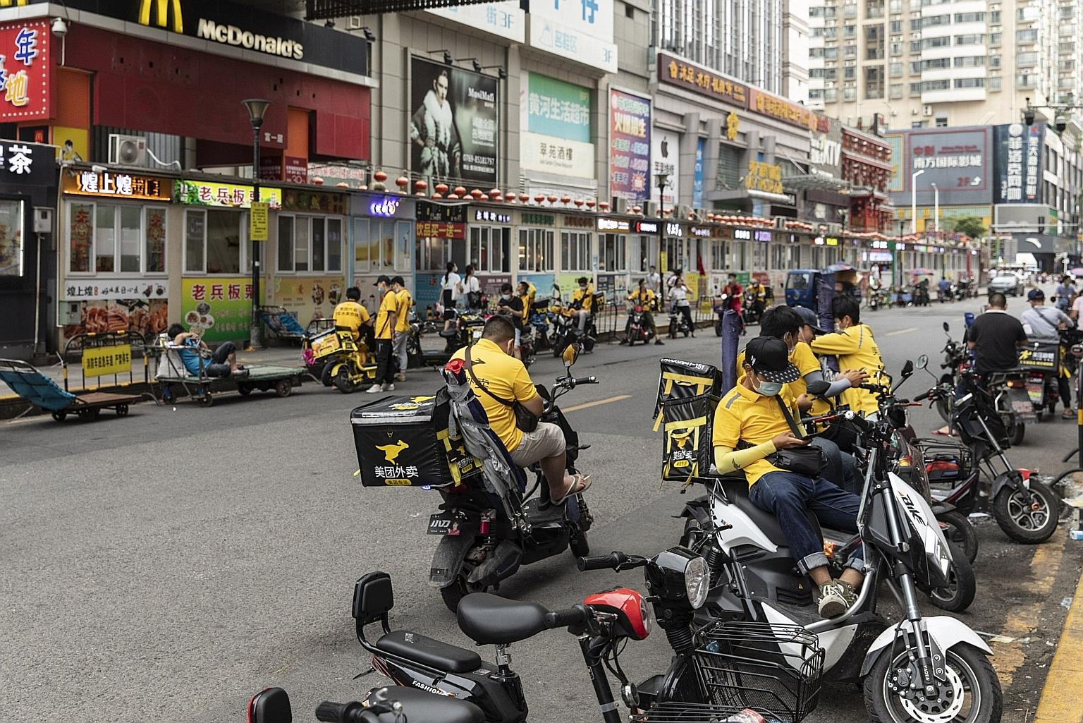 Food delivery couriers for Meituan in the Humen area of Dongguan, Guangdong province. Meituan intends to use the proceeds for technology innovations, including drone delivery and other cutting-edge technology.