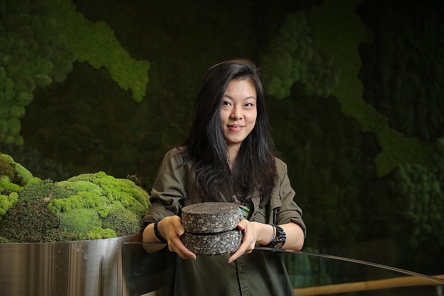 Magorium co-founder Oh Chu Xian with prototypes of road construction material the start-up has developed. The firm's road construction material prototypes have incorporated plastic bottles, plastic bags and milk cartons - waste that has been reproces