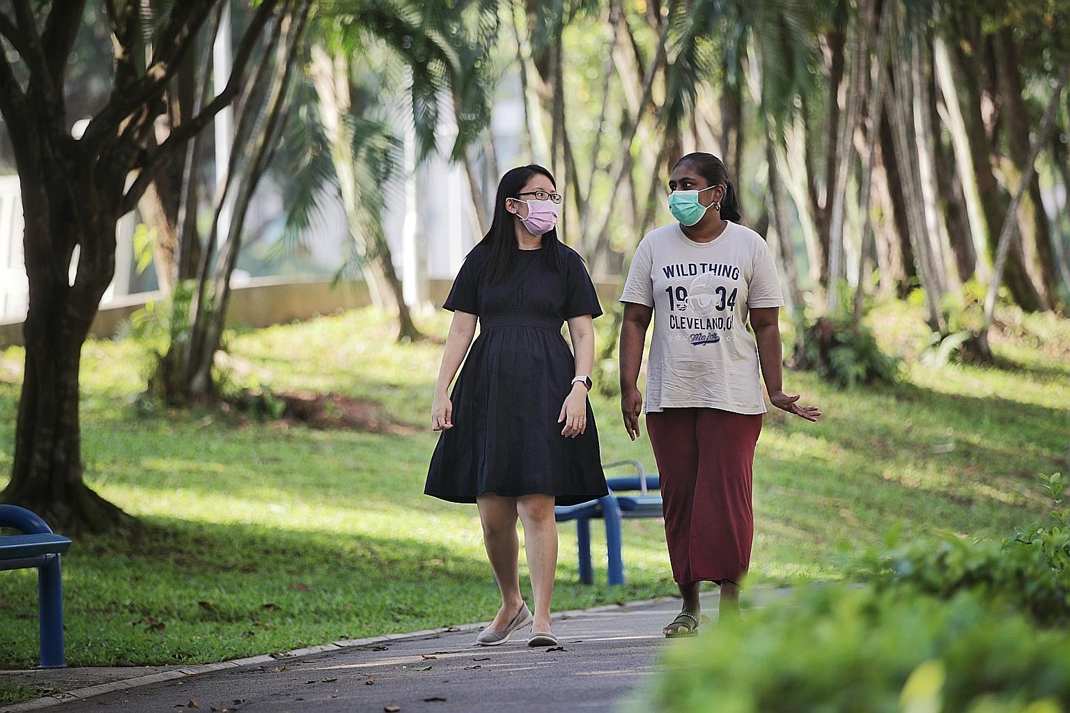 Ms Tay Yu Ping, a senior social worker with the Movement for the Intellectually Disabled of Singapore, with Ms Shantini Murugiah at Limbang Park during a community walk yesterday. In August 2019, social workers stepped in and identified Ms Shantini a