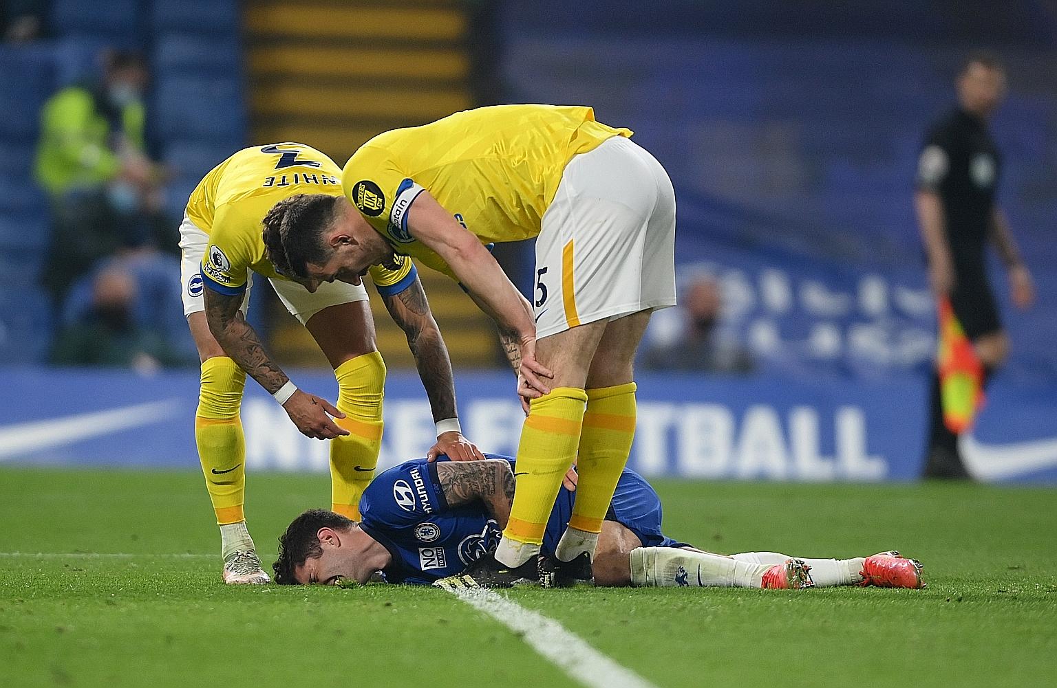 Chelsea forward Christian Pulisic lying down in pain after suffering an injury during the 0-0 Premier League draw with Brighton on Tuesday. The result moved the Blues up to fourth ahead of West Ham, but only on goal difference. PHOTO: REUTERS