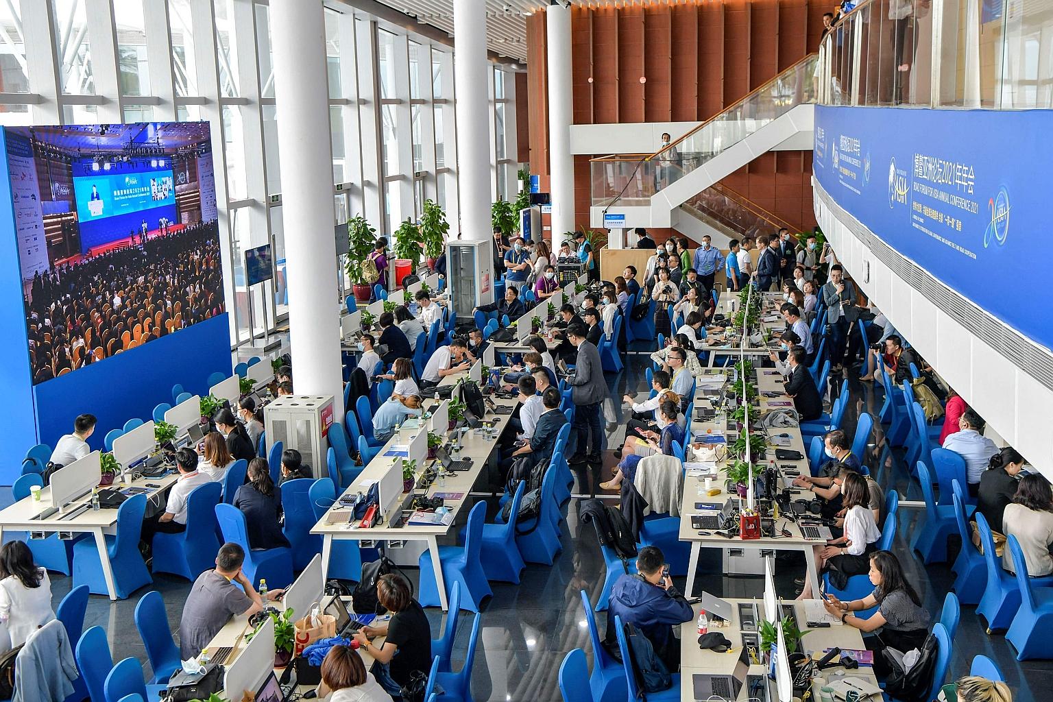 Journalists watching a live screening of the opening of the Boao Forum in Hainan province on Tuesday. Most - if not all - foreign delegates who spoke at the forum delivered their remarks virtually, meaning that socialising and networking, usually key