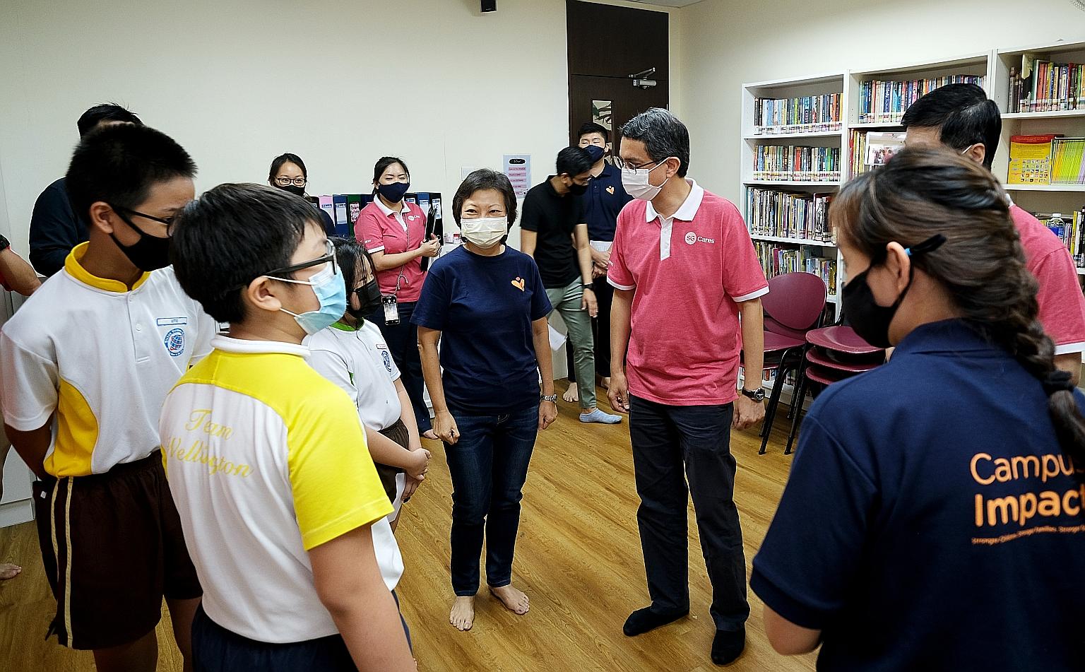 Minister of State for Home Affairs and National Development Muhammad Faishal Ibrahim, with former IT executive Lilian Chua next to him, at the official launch of the new SG Cares VC @ Yishun yesterday.